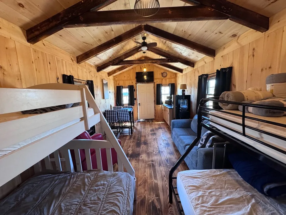 Bunk beds and the pine-lined interior of the Green Door Cabin