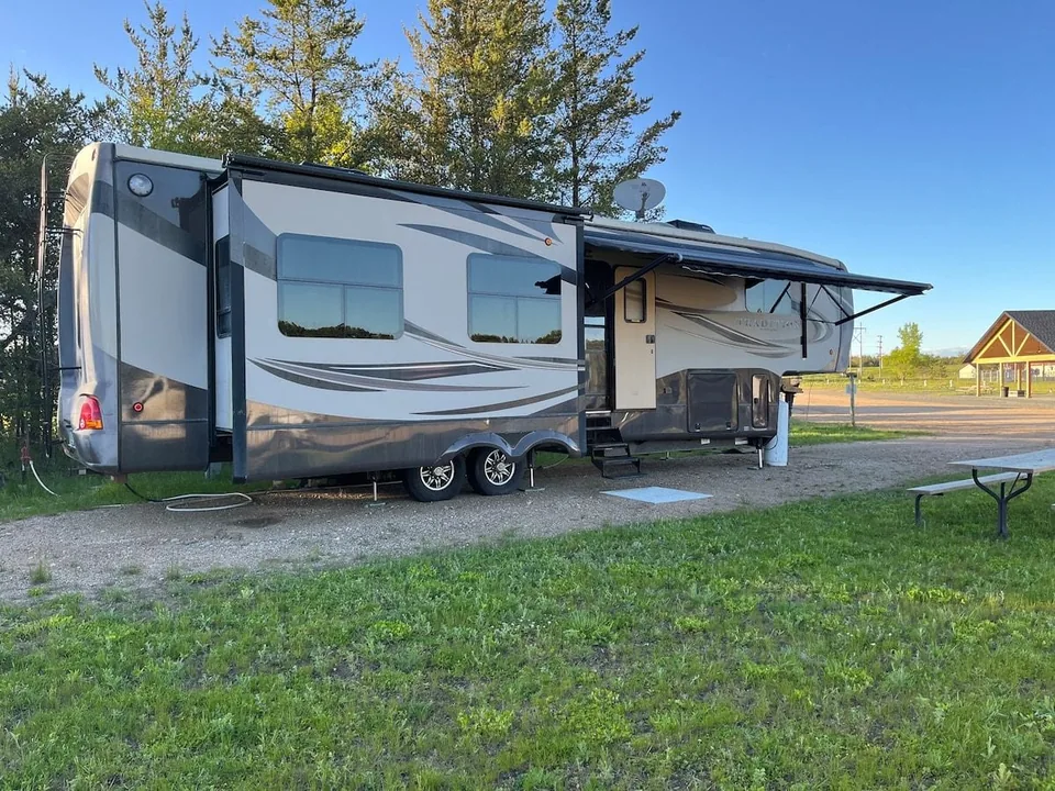 Grant Haven Premier Suite fifth-wheel camper with a covered patio area